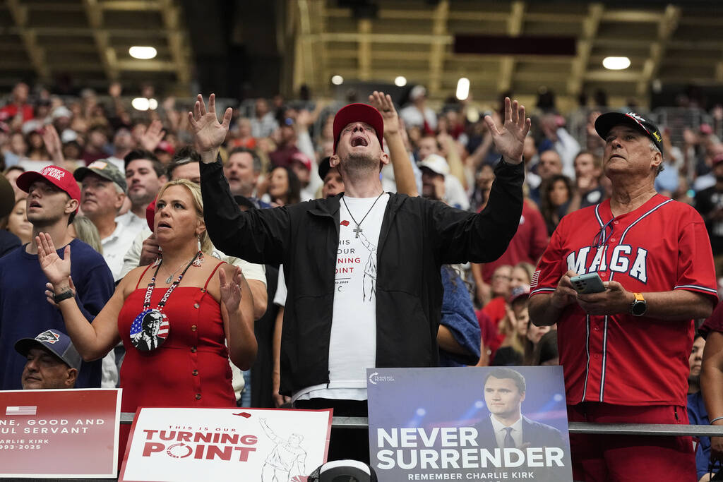 A man listens during a worship song before the start of a memorial for conservative activist Ch ...