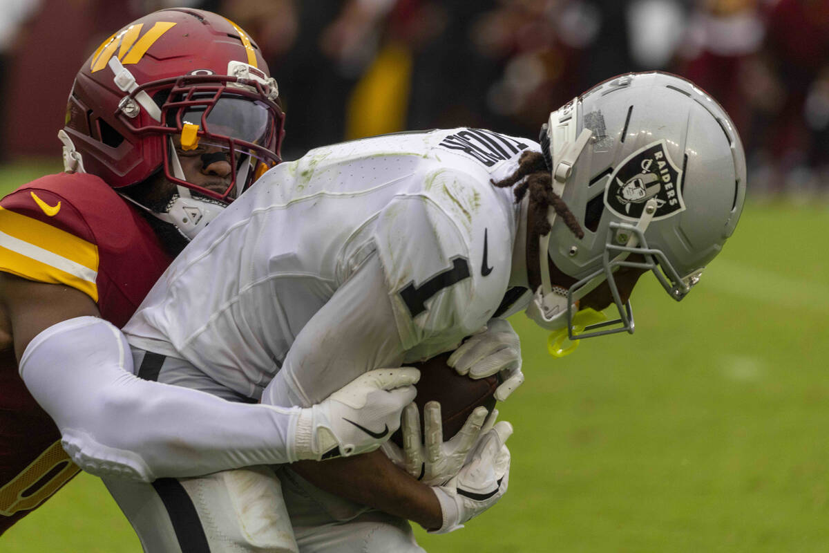 Raiders wide receiver Tre Tucker (1) makes a catch with Washington Commanders cornerback Noah I ...