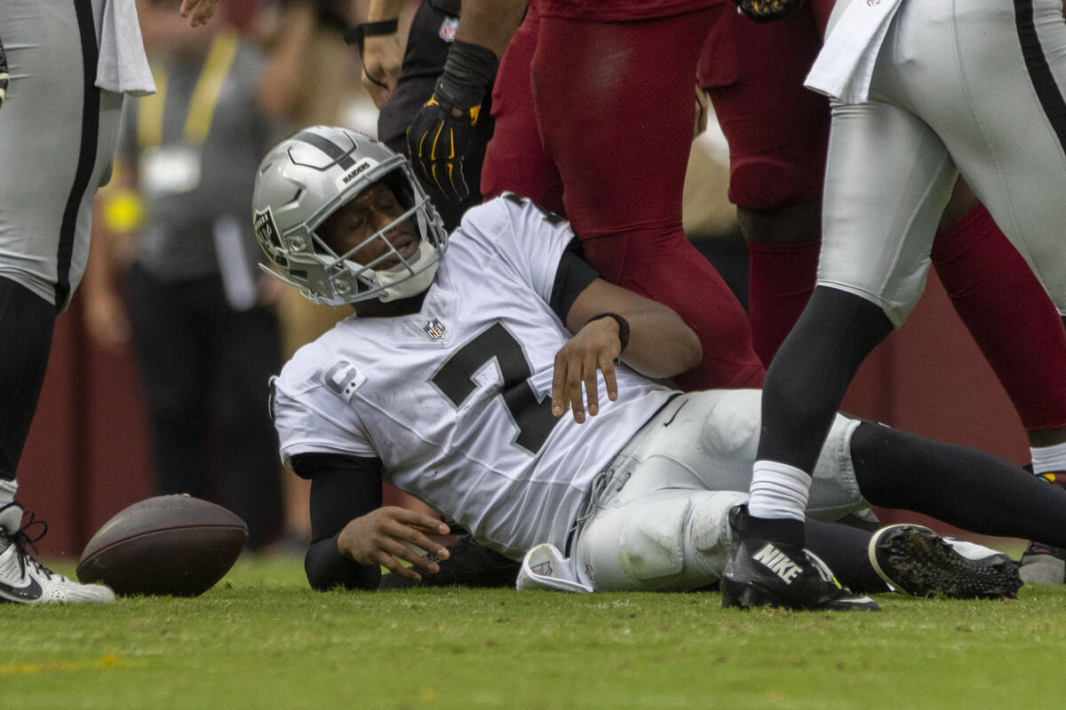 Raiders quarterback Geno Smith (7) reacts to being sacked during the first half of an NFL game ...