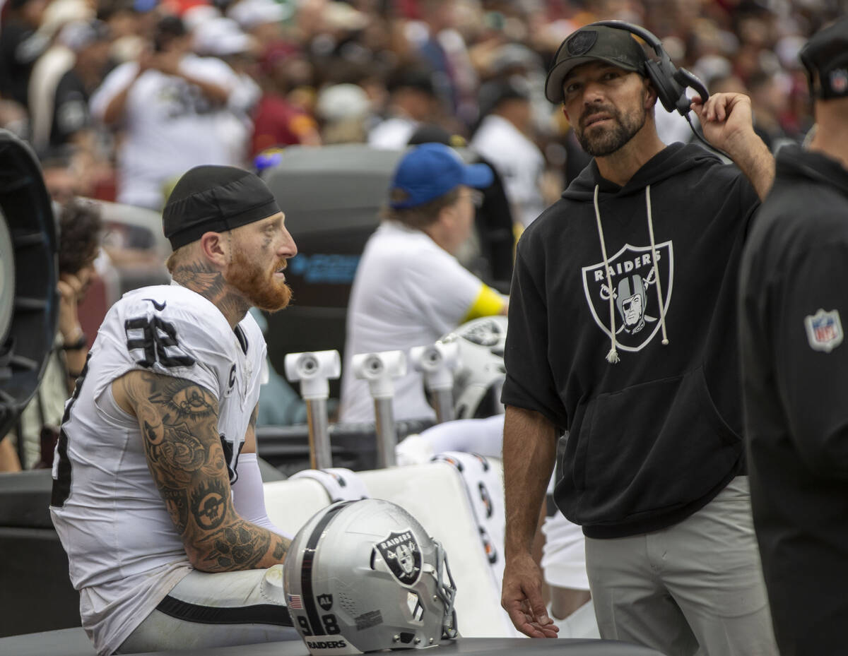 Raiders defensive end Maxx Crosby (98) speaks with defensive line coach Rob Leonard during the ...