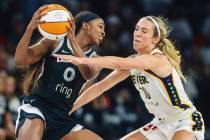 Aces guard Jackie Young (0) tries to pass the ball as Indiana Fever guard Lexie Hull (10) defen ...