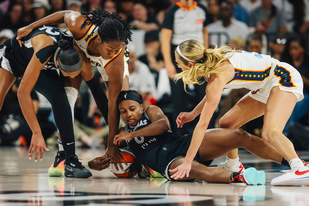 Aces guard Jackie Young (0) tries to grab the ball during game one of a round two WNBA playoff ...