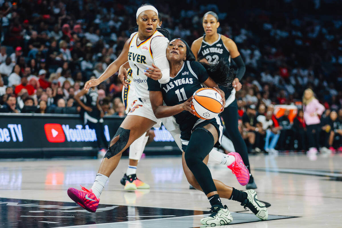 Aces guard Dana Evans (11) drives the ball against Indiana Fever guard Odyssey Sims (1) during ...