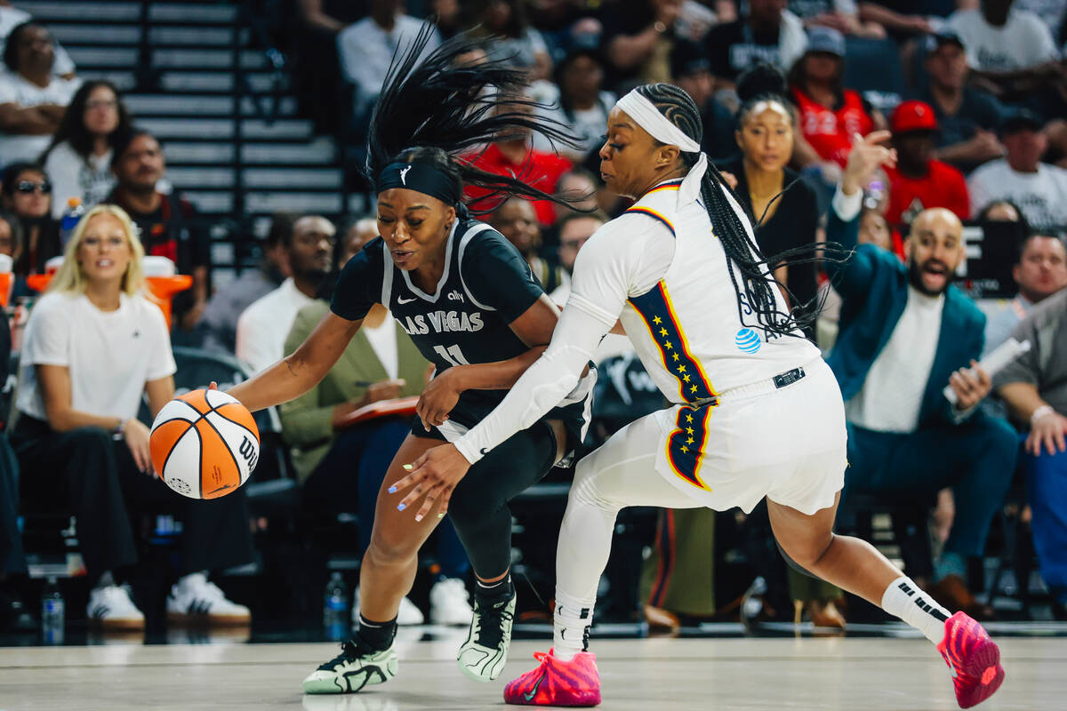Aces guard Dana Evans (11) moves the ball as Indiana Fever guard Odyssey Sims (1) defends durin ...