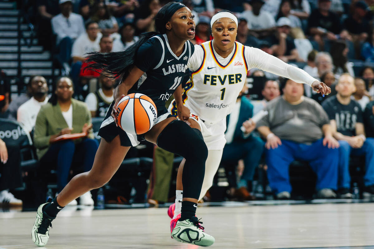 Aces guard Dana Evans (11) moves the ball as Indiana Fever guard Odyssey Sims (1) defends durin ...