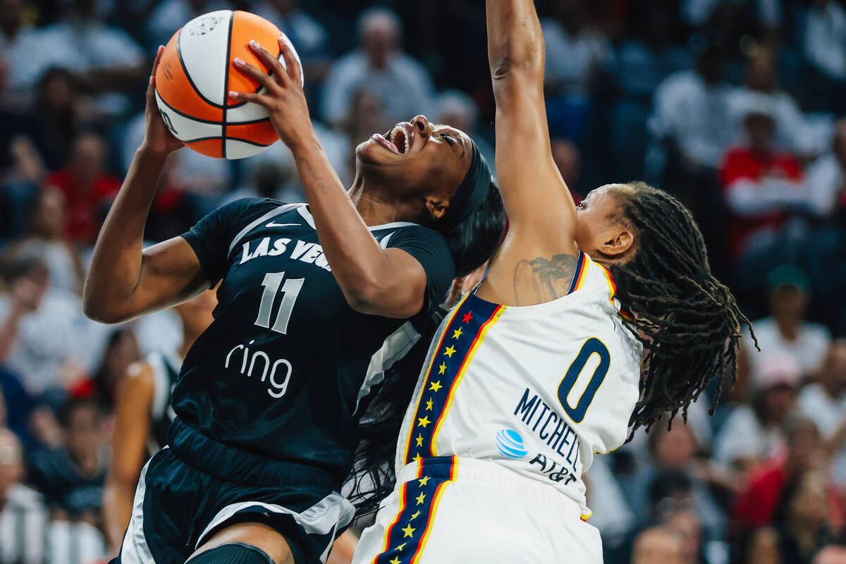 Aces guard Dana Evans (11) fights to put up a shot during game one of a round two WNBA playoff ...