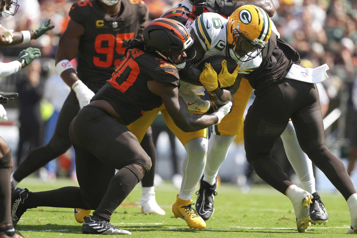 Green Bay Packers running back Josh Jacobs (8) carries the ball as Cleveland Browns linebacker ...