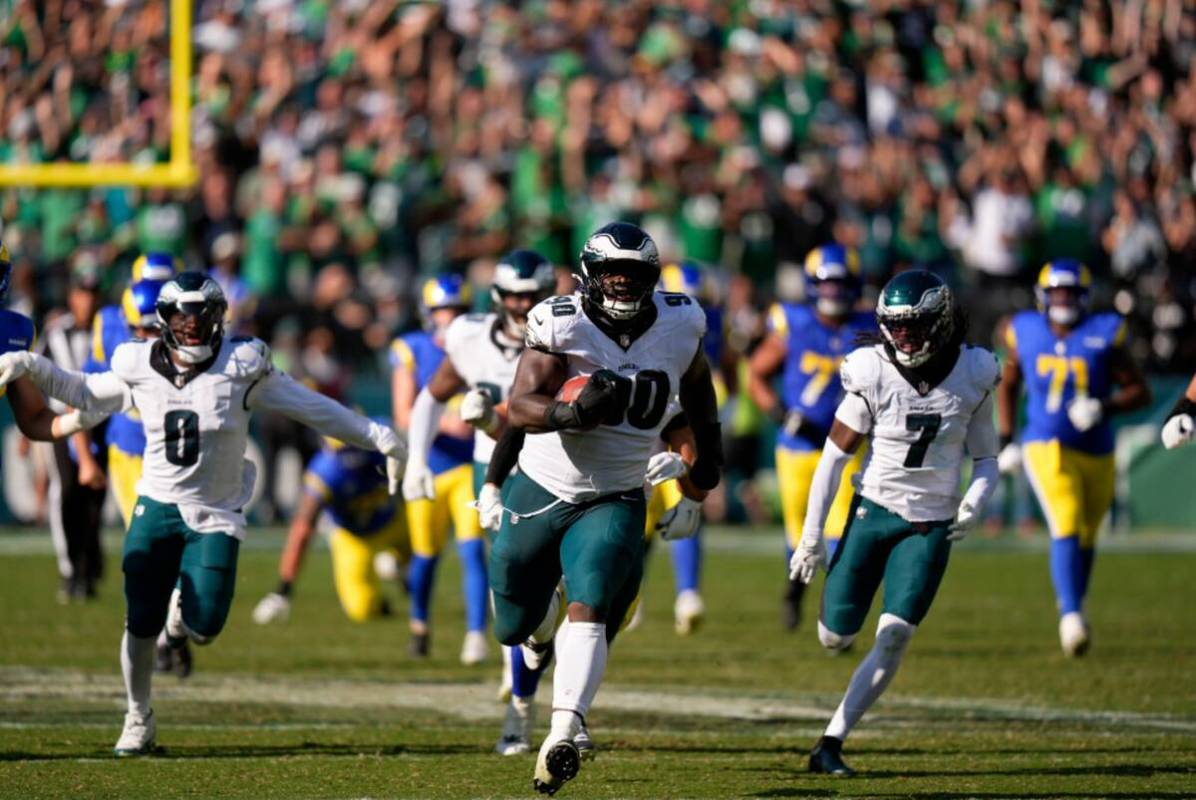 Philadelphia Eagles defensive tackle Jordan Davis (90) runs the ball back for a touchdown after ...