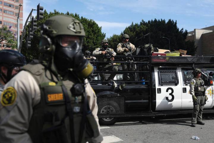 Law enforcement officers stand guard during a protest June 14, 2025, in Los Angeles. (AP Photo/ ...