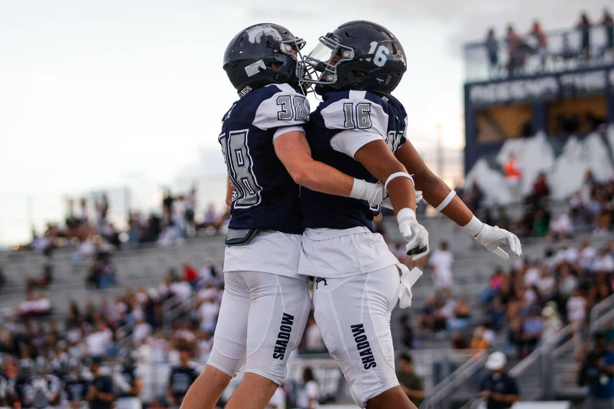 Shadow Ridge's Hawkin Ledingham (38) and Isiah Jones (16) jump in the air in celebration after ...