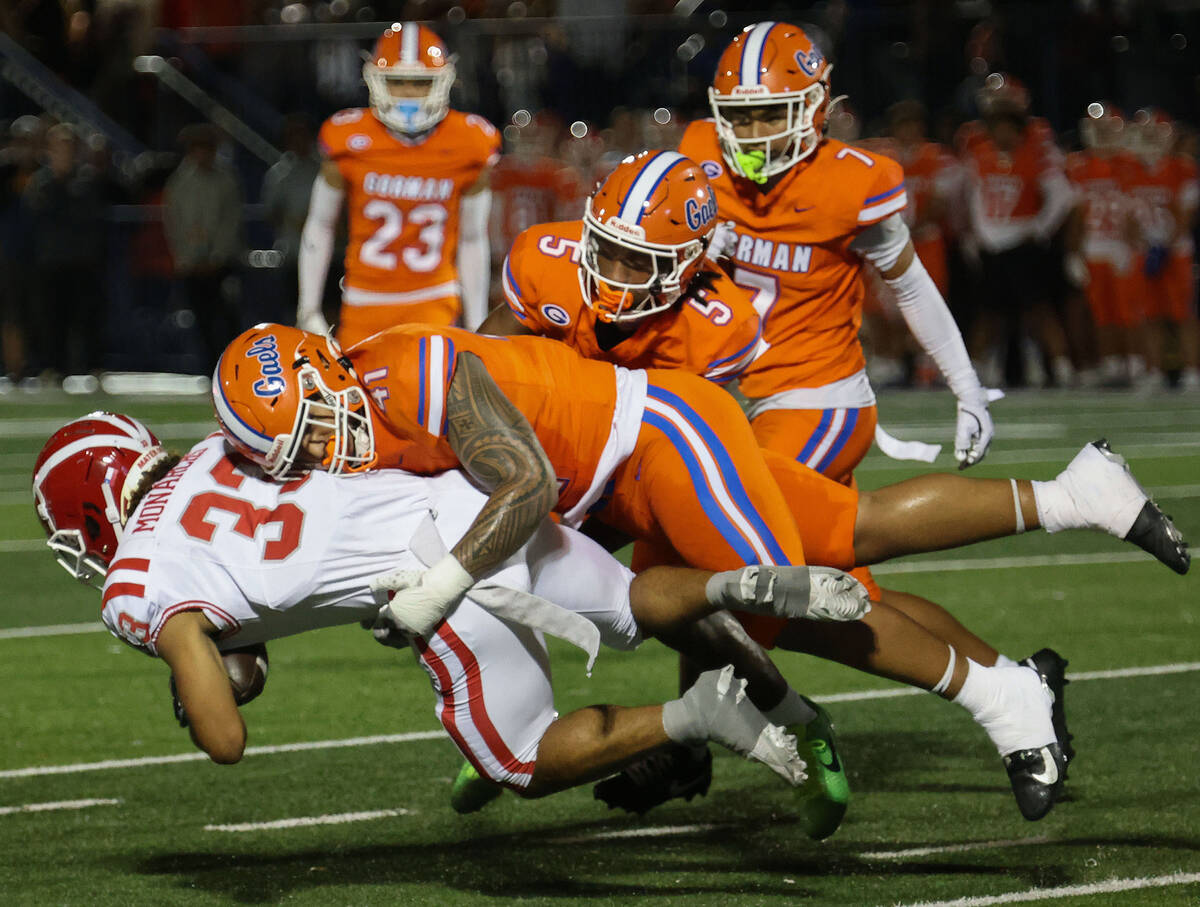 Bishop Gorman defensive lineman Prince Williams (41) tackles Mater Dei running back Justin Lewi ...