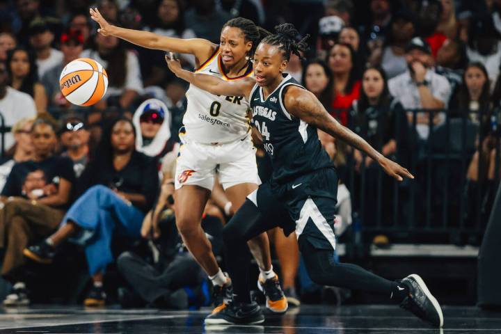 Aces guard Jewell Loyd (24) and Indiana Fever guard Kelsey Mitchell (0) chase a loose ball duri ...