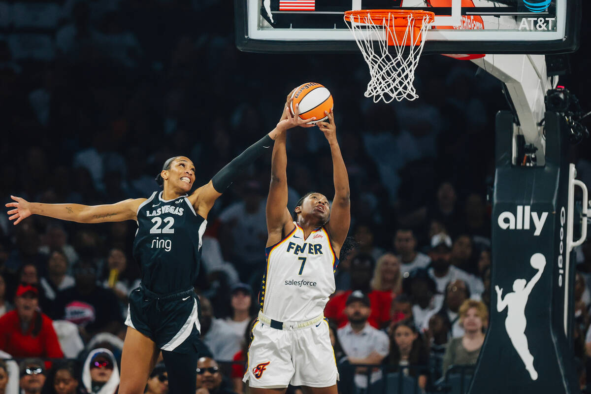 Indiana Fever forward Aliyah Boston (7) grabs the ball as Aces center A'ja Wilson (22) tri ...
