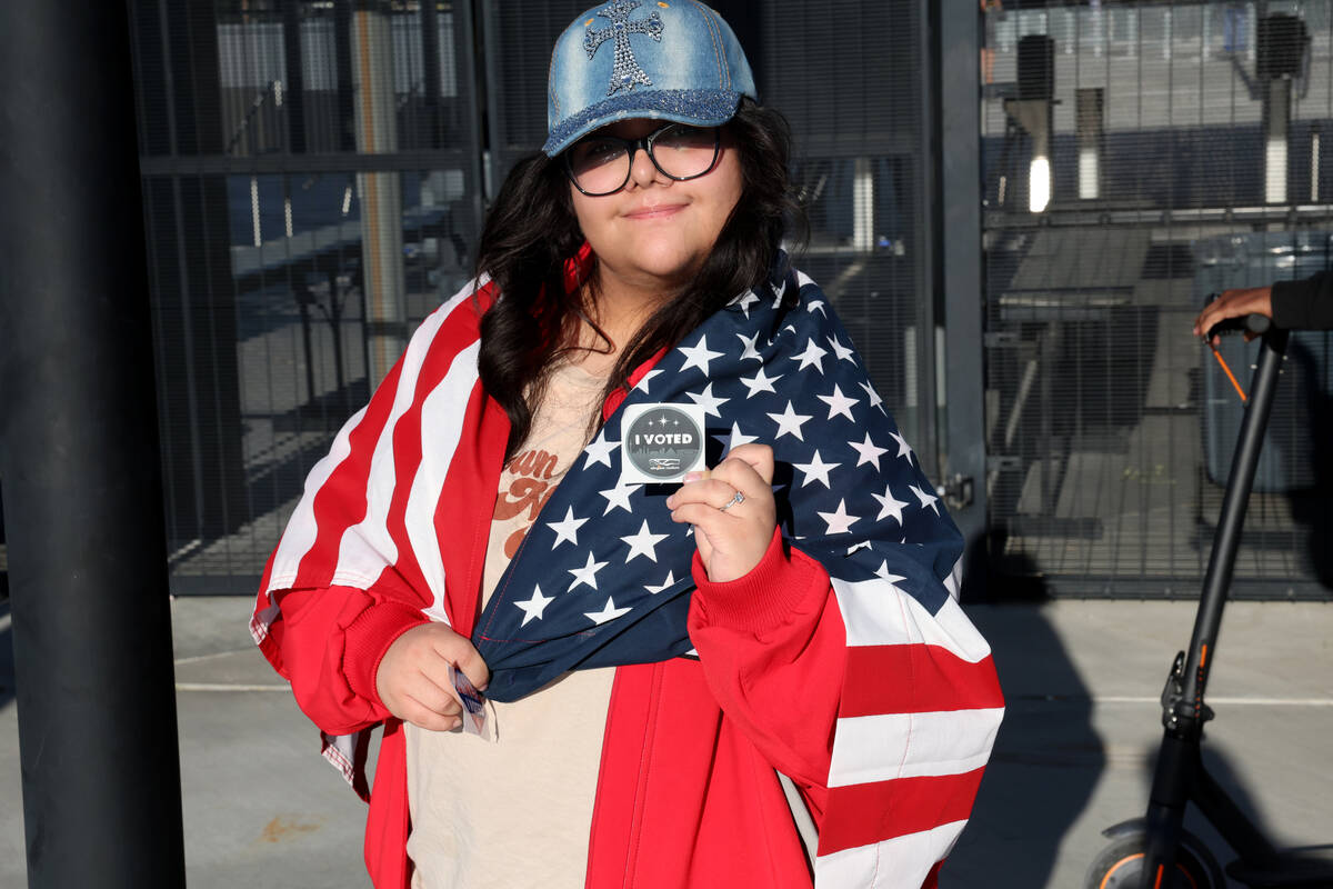 Ammy Rivera of Las Vegas shows her unique Allegiant Stadium “I VOTED” sticker after casting ...