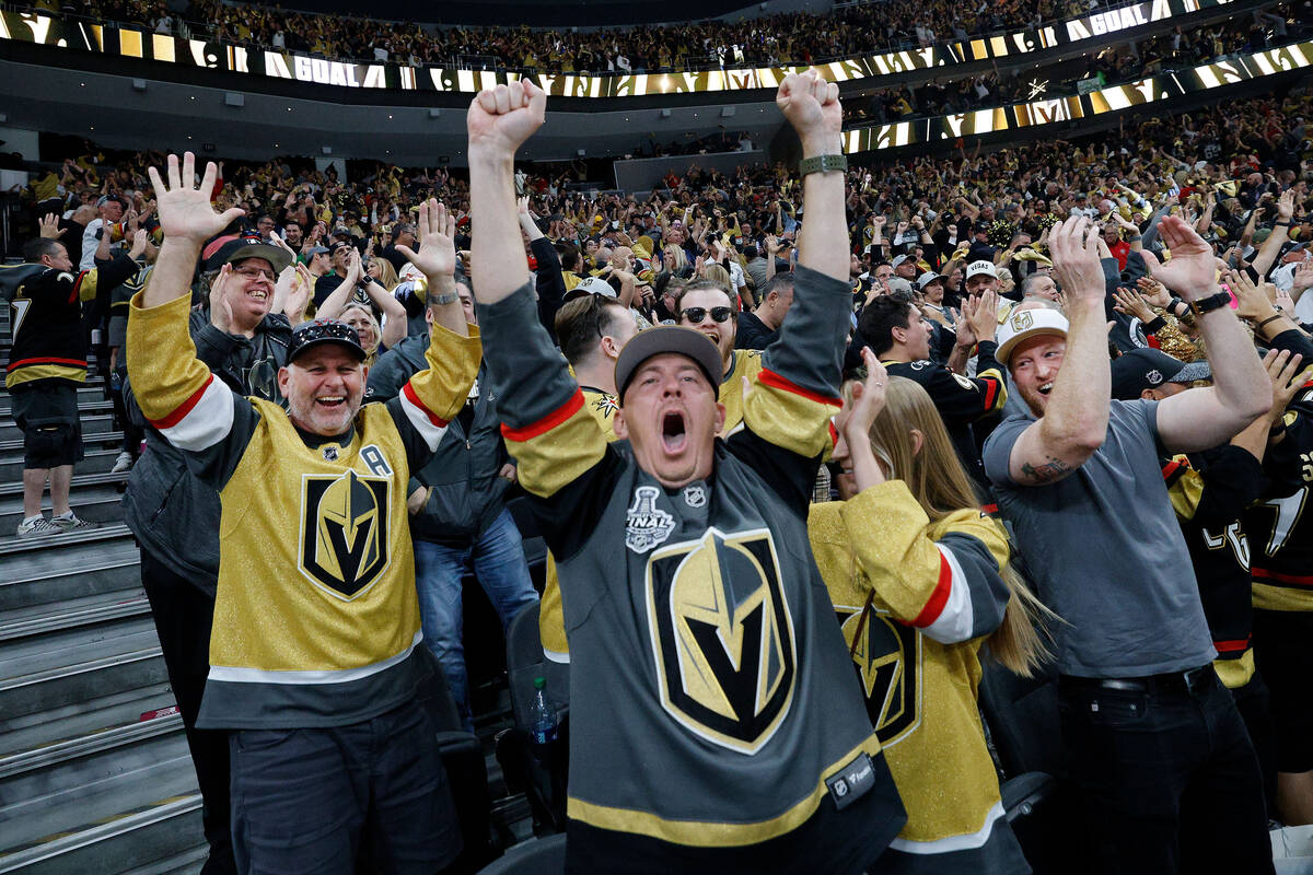 Golden Knights fans react after Golden Knights defenseman Zach Whitecloud (2) scored a goal aga ...