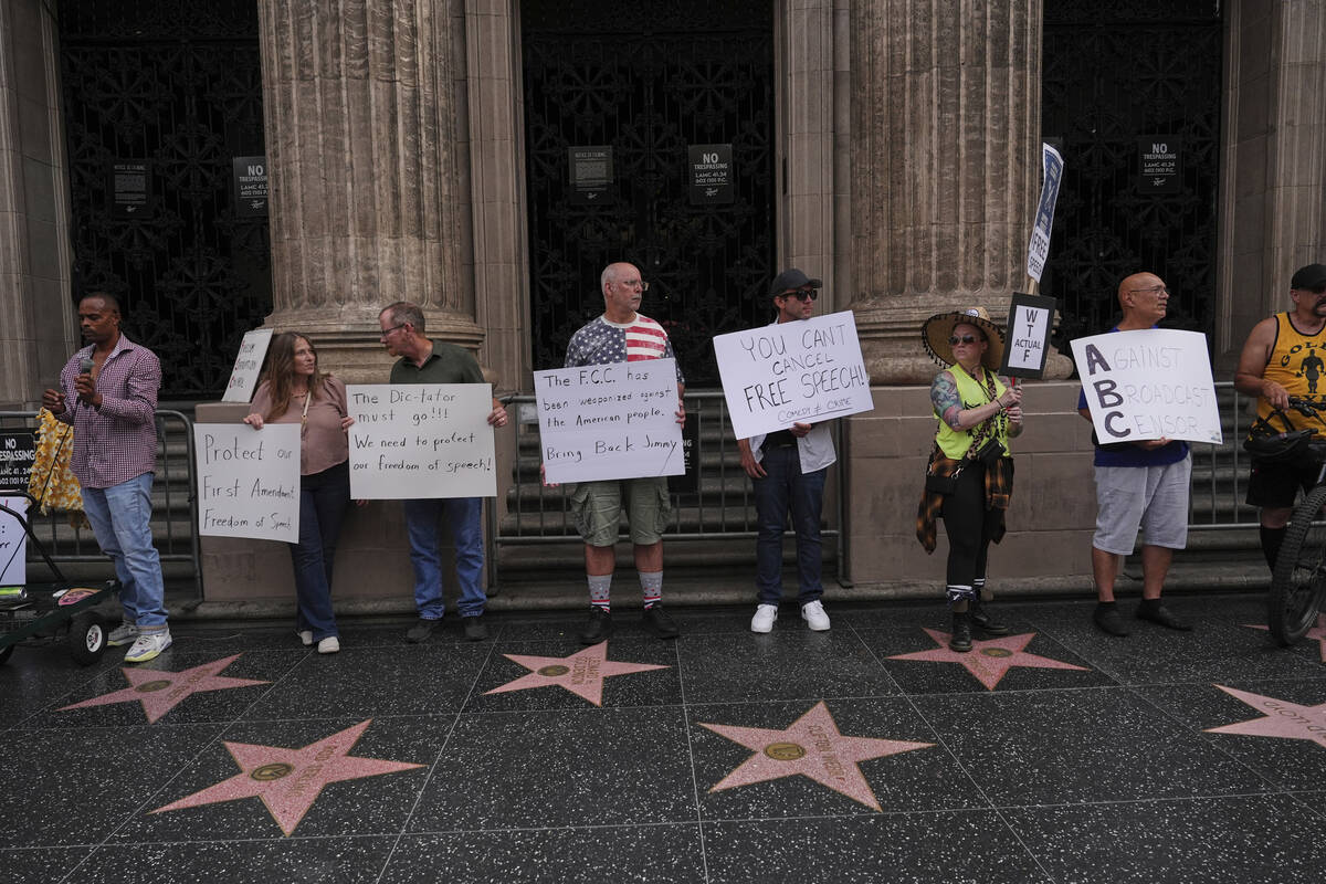 Demonstrators hold signs outside El Capitan Entertainment Centre, where the late-night show &qu ...