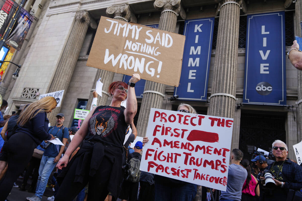 Demonstrators hold signs outside El Capitan Entertainment Centre, where the late-night show &qu ...
