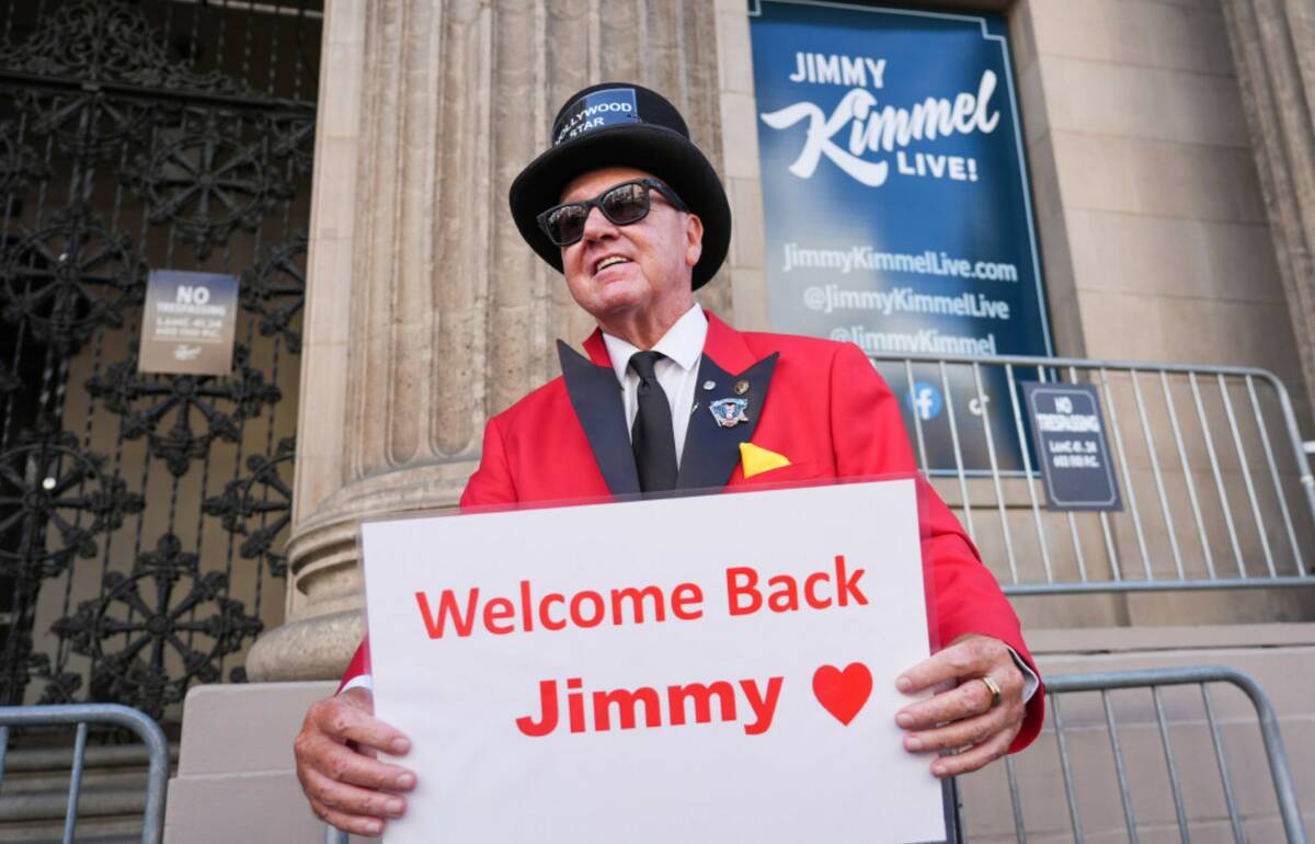 Gregg Donovan holds a sign that says "Welcome Back Jimmy" in front of the Jimmy Kimmel Live stu ...