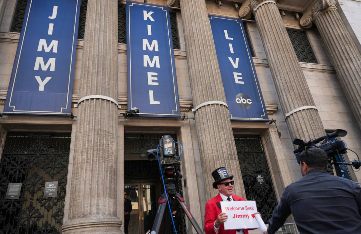 Gregg Donovan holds a sign that says "Welcome Back Jimmy" in front of the Jimmy Kimmel Live stu ...