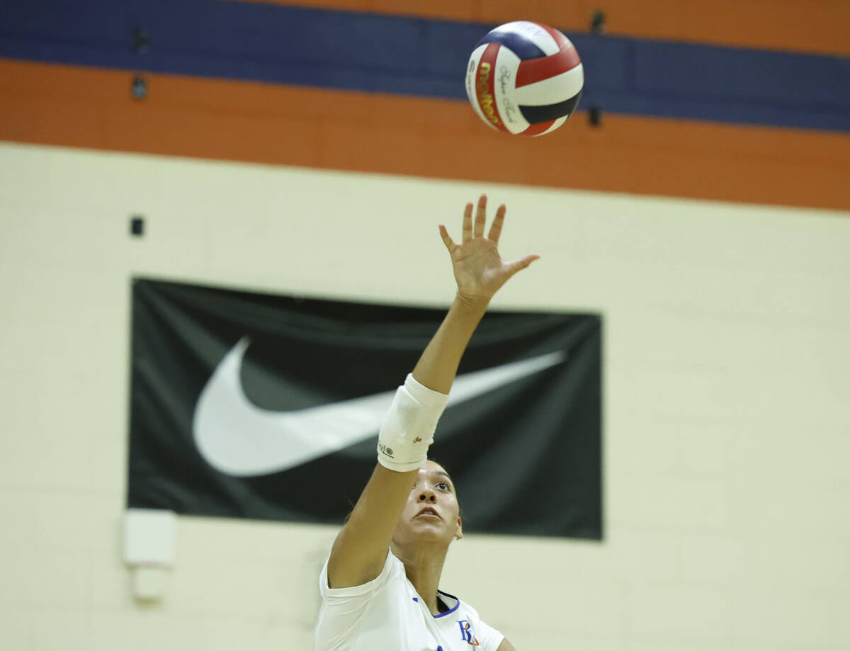 Bishop Gorman's Ayanna Watson serves during their home matchup with Shadow Ridge on Tuesda ...