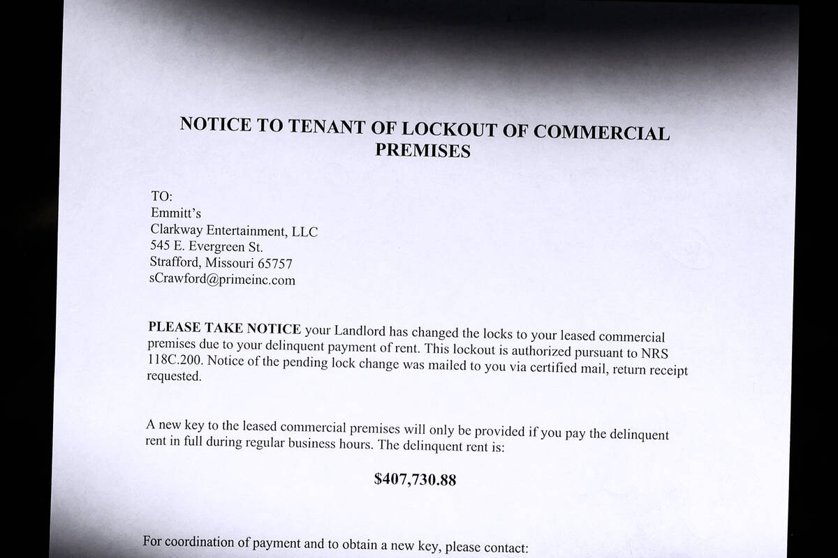 A notice stating the total unpaid rent balance of $407,730,88 is posted on a glass door at Emmi ...