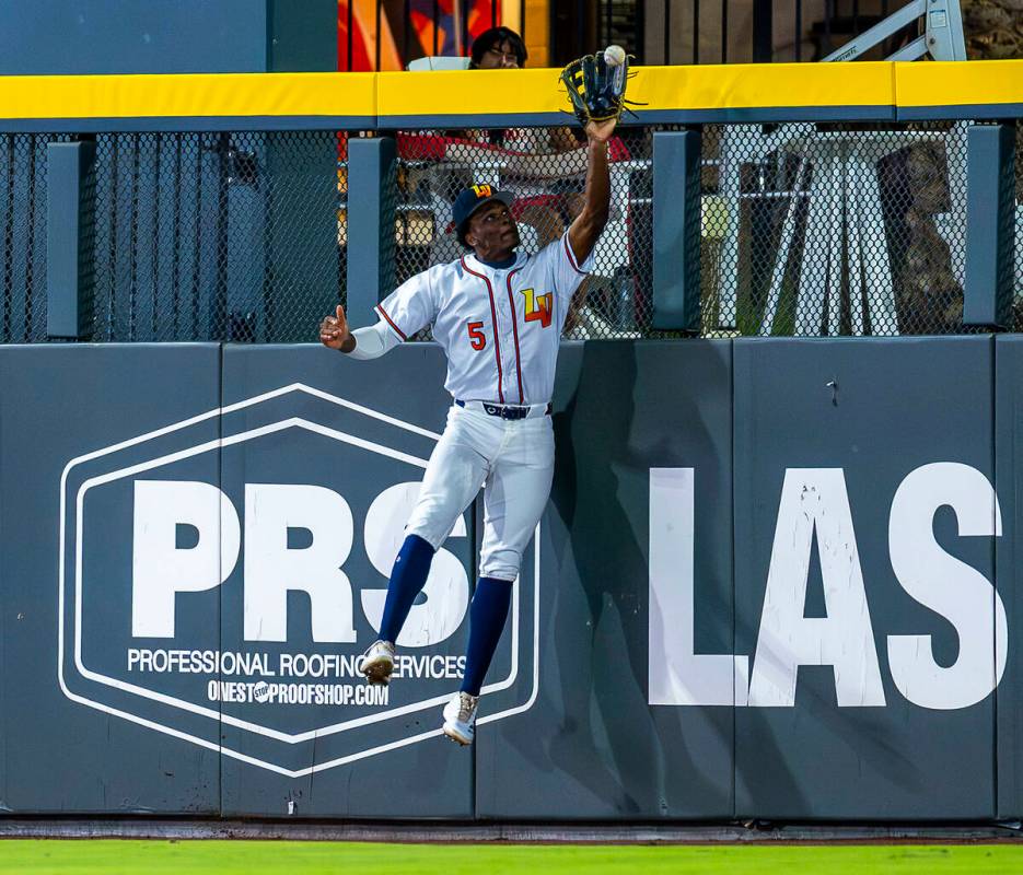 Aviators outfielder Denzel Clarke (5) elevates at the wall for an out against the Tacoma Rainie ...