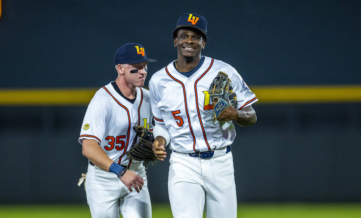 Aviators outfielder Denzel Clarke (5) is congratulated by teammate outfielder Ryan Lasko (35) a ...