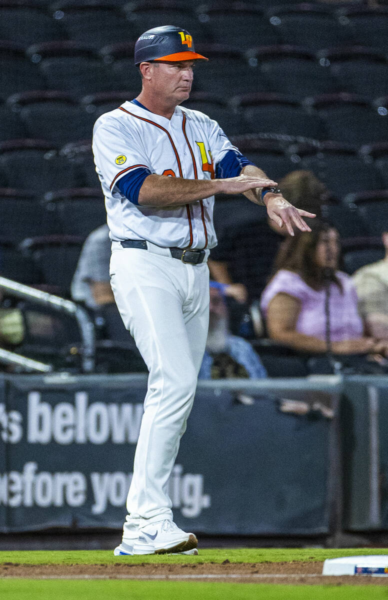 Aviators manager Fran Riordan signals his player on base against the Tacoma Rainiers during Gam ...