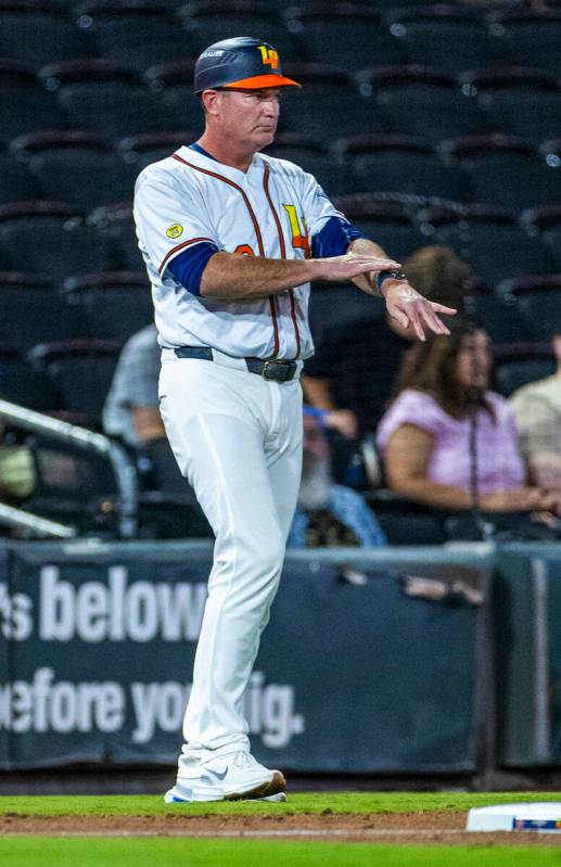 Aviators manager Fran Riordan signals his player on base against the Tacoma Rainiers during Gam ...