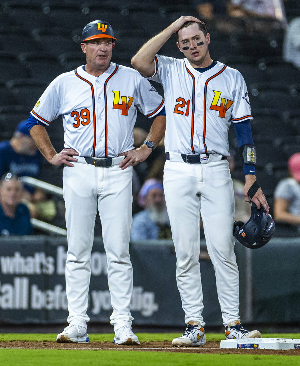 Aviators manager Fran Riordan talks with catcher Daniel Susac (21) on base against the Tacoma R ...
