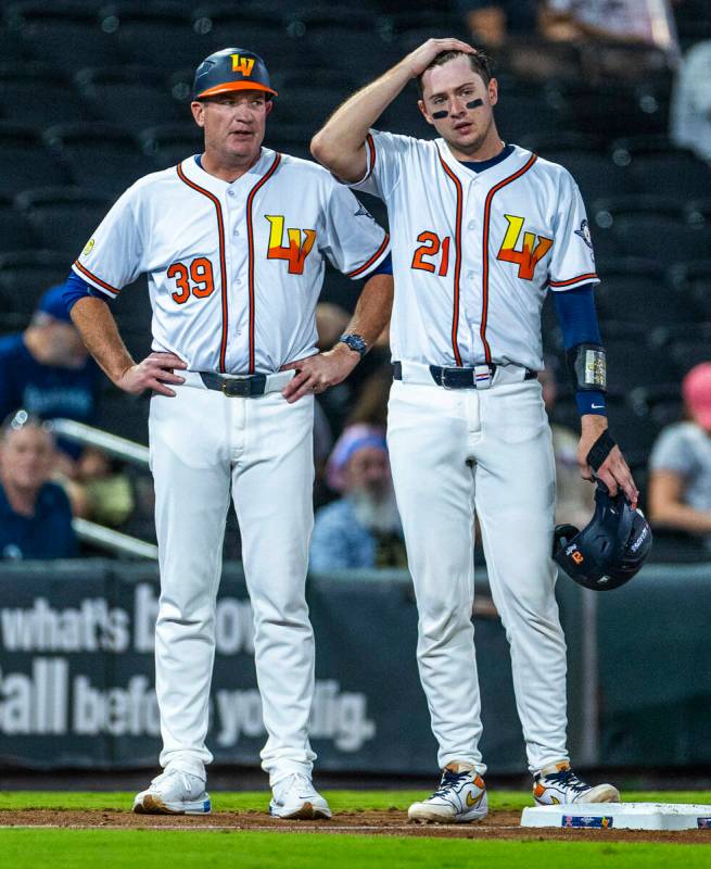 Aviators manager Fran Riordan talks with catcher Daniel Susac (21) on base against the Tacoma R ...