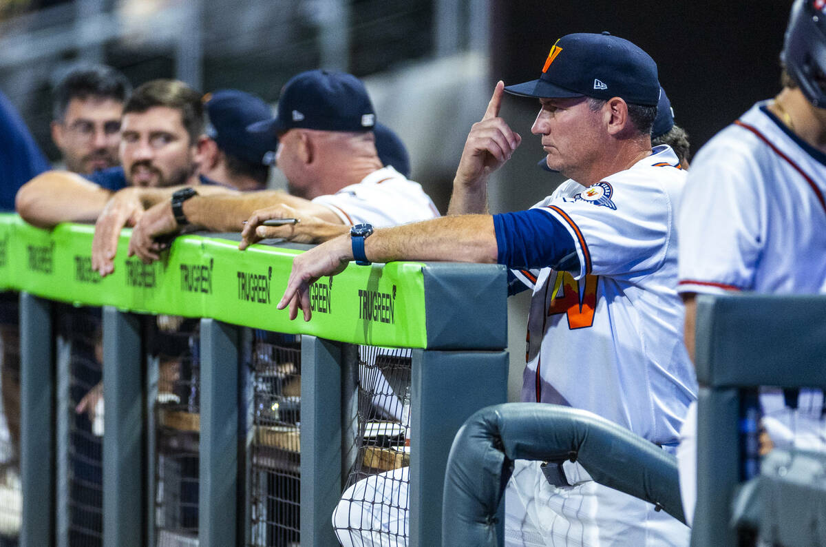 Aviators manager Fran Riordan sends a signal from the dugout against the Tacoma Rainiers during ...