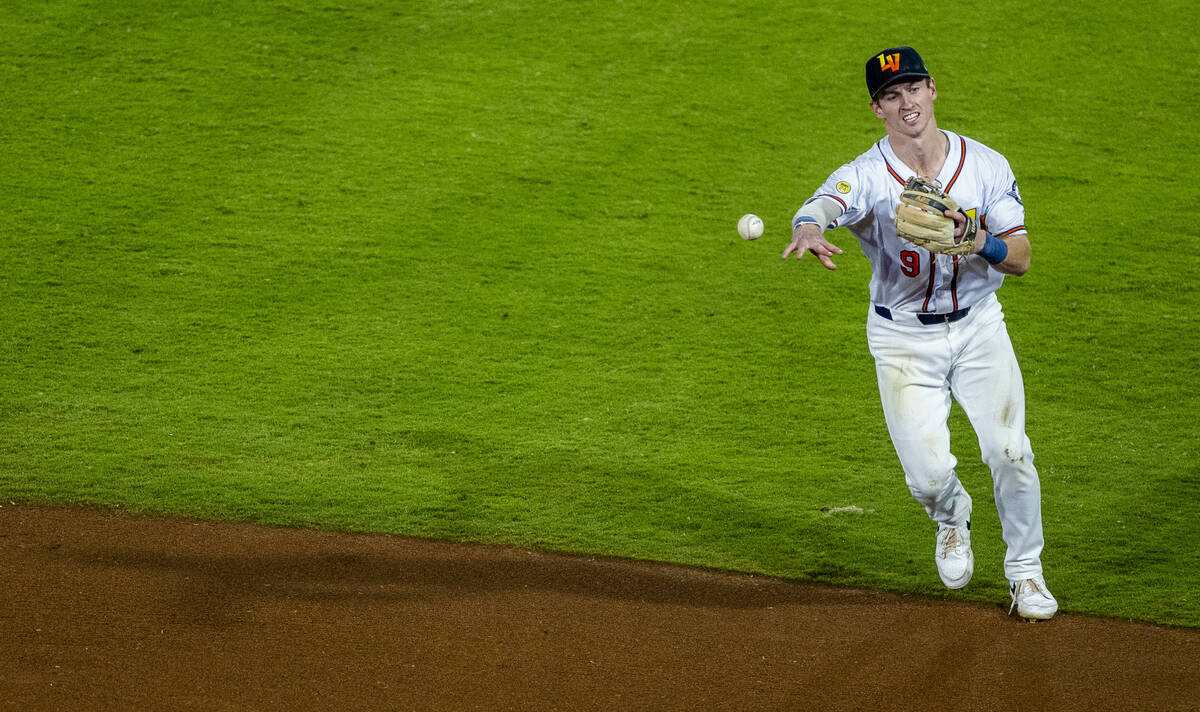 Aviators infielder Cooper Bowman (9) tosses a catch to first base for an out against the Tacoma ...
