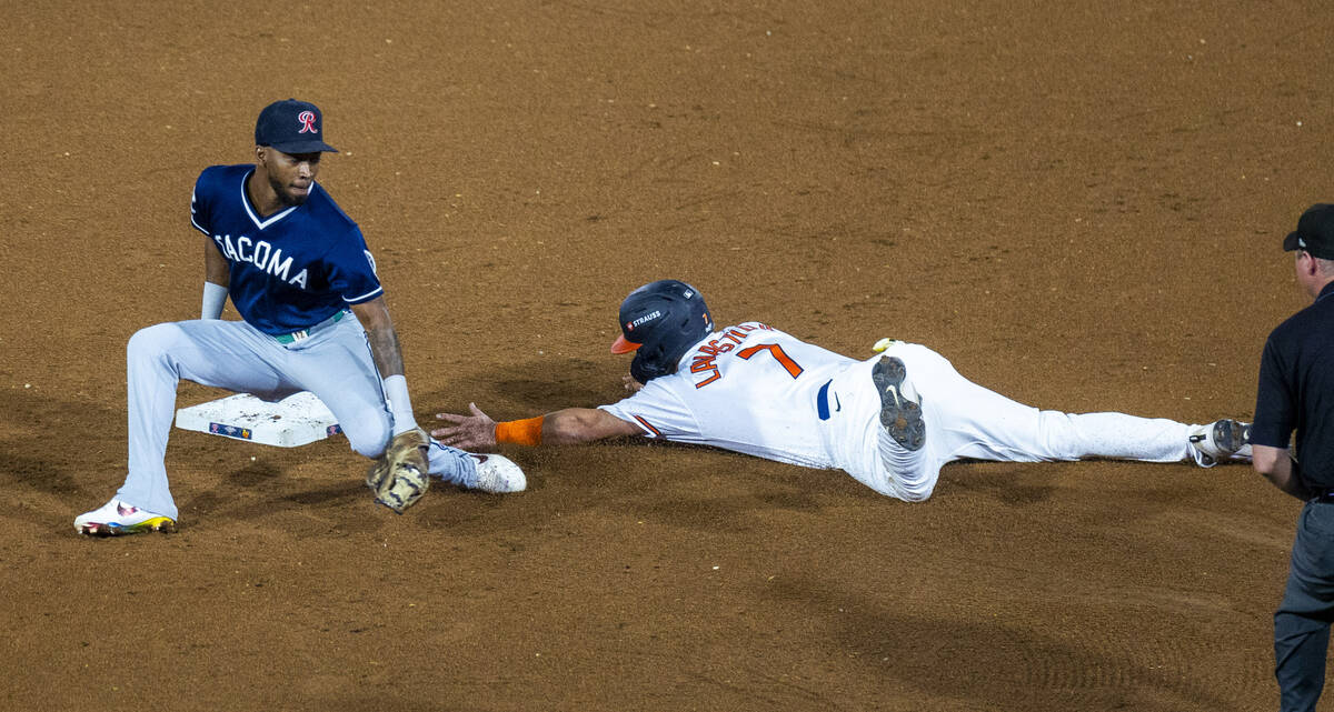 Aviators catcher Bryan Lavastida (7) slides into second base just ahead of a tag by Tacoma Rain ...