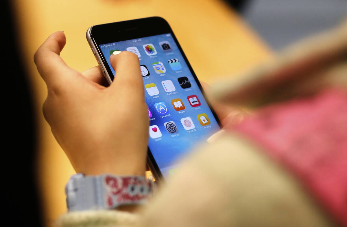 FILE - A child holds an iPhone at an Apple store on Sept. 25, 2015 in Chicago. (AP Photo/Kiichi ...