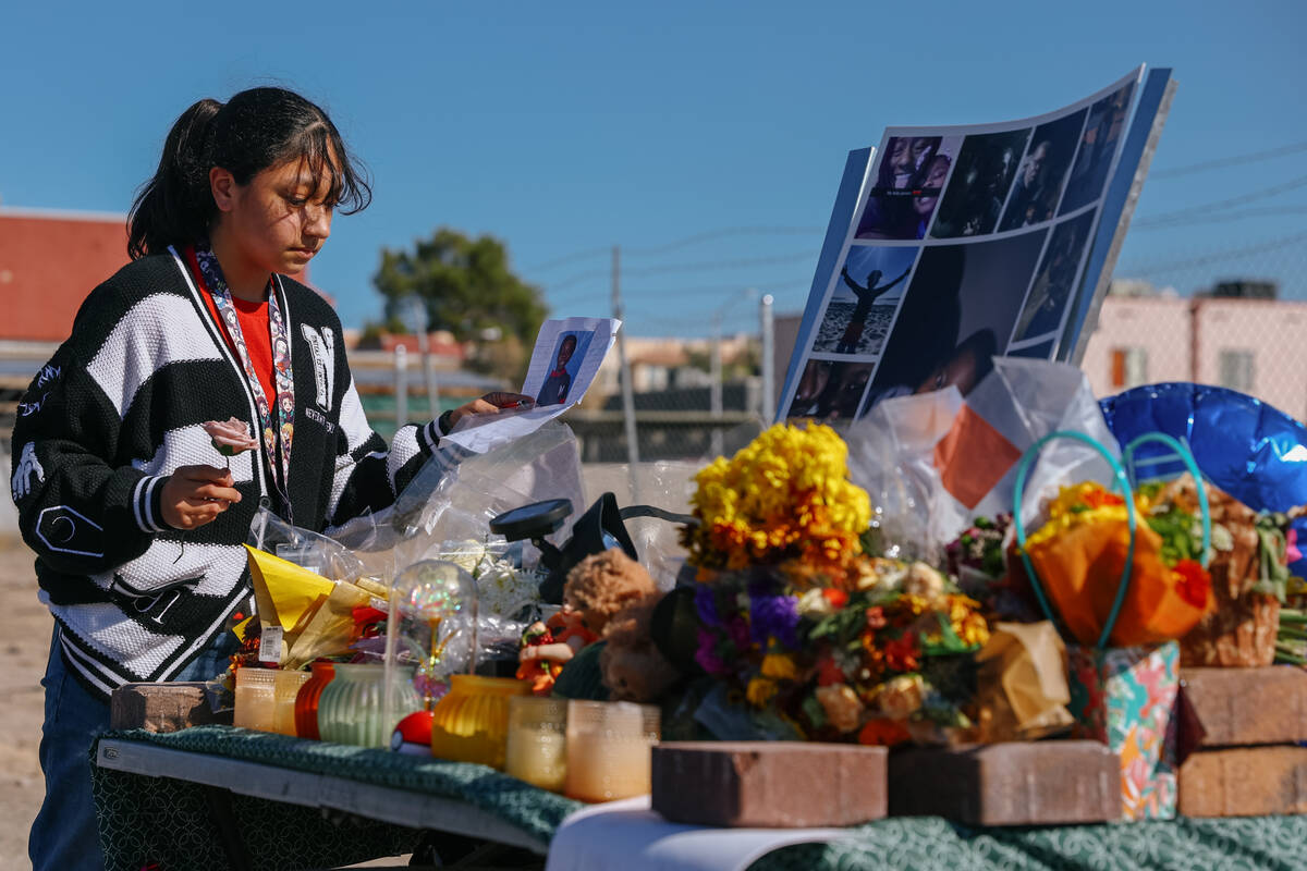 Bella Garcia Ortega, 12, places items on a makeshift memorial for Jovonn “JoJo” Magee-Thoma ...