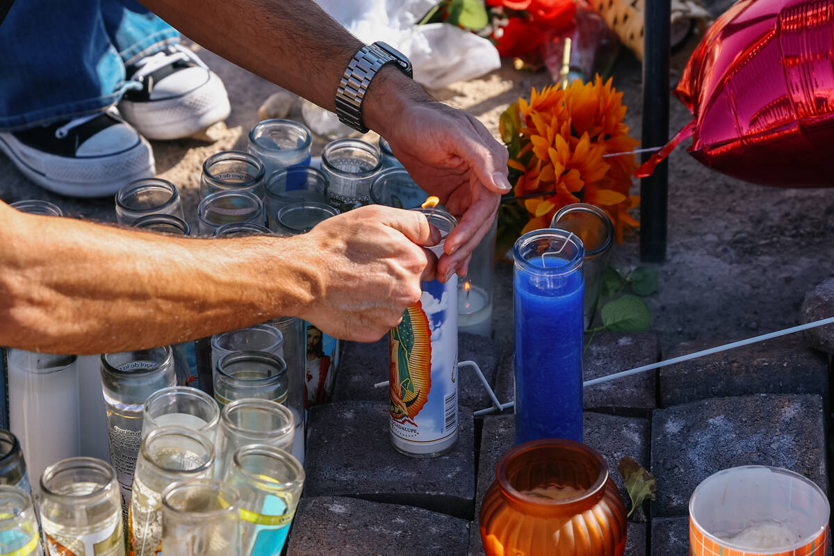 Oscar Garcia Romero lights prayer candles at a makeshift memorial for Jovonn “JoJo” Magee-T ...