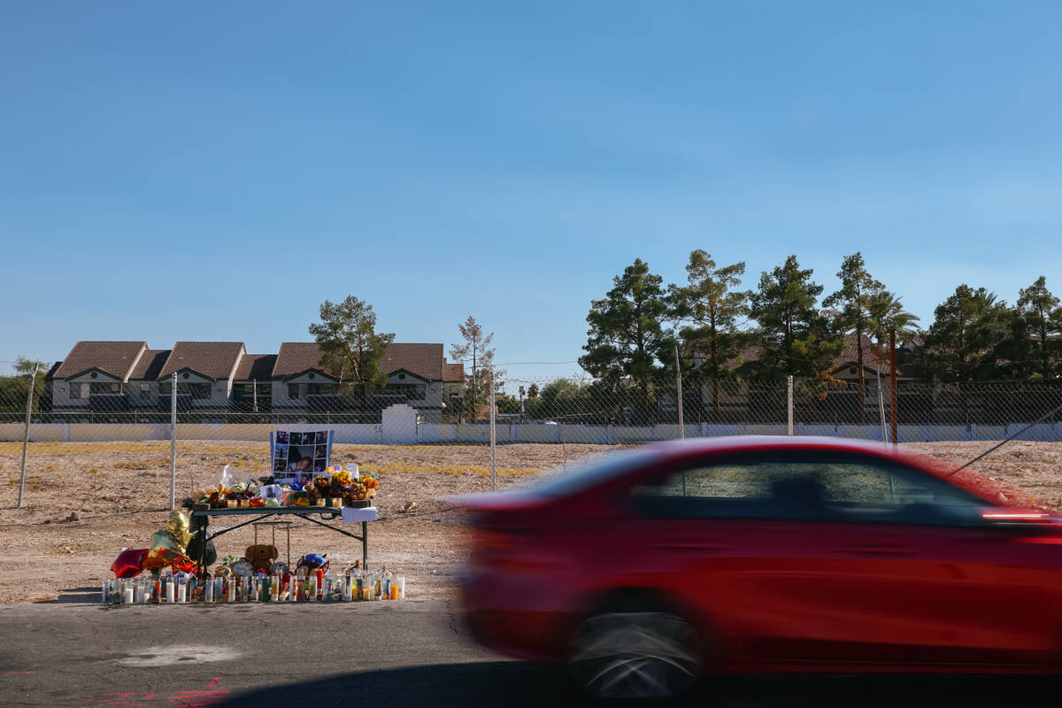 A car drives by a makeshift memorial for Jovonn “JoJo” Magee-Thomas, a 12-year-old who was ...