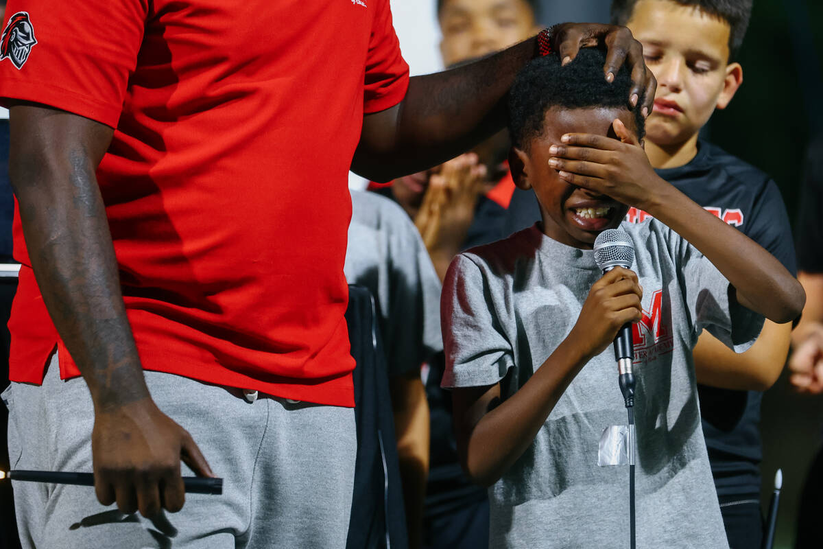 Mater Academy East boys’ flag football coach Marquise Harris comforts one of Jojo’s teammat ...