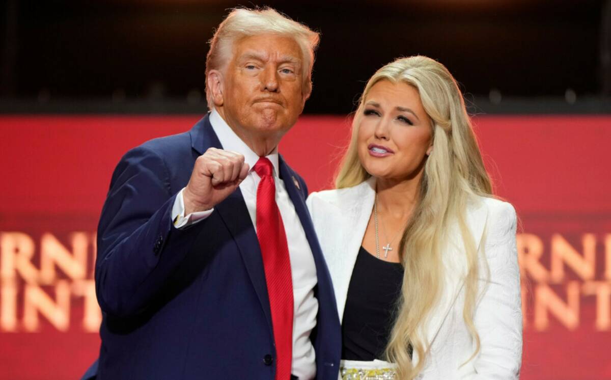 President Donald Trump, left, stands with Erika Kirk at the memorial of her husband, conservati ...