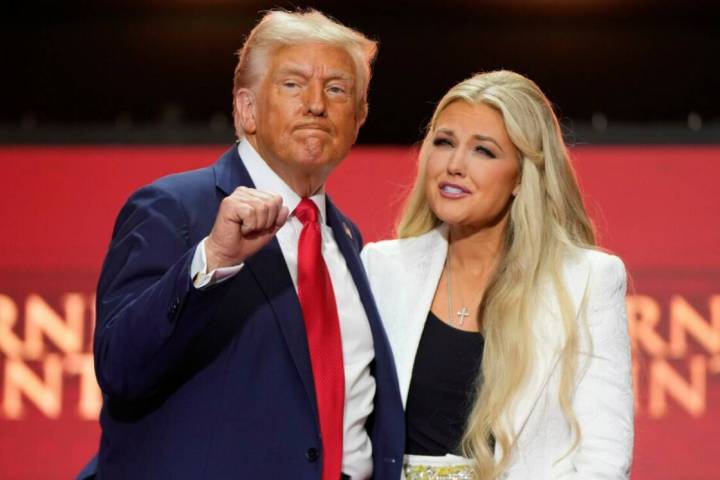 President Donald Trump, left, stands with Erika Kirk at the memorial of her husband, conservati ...