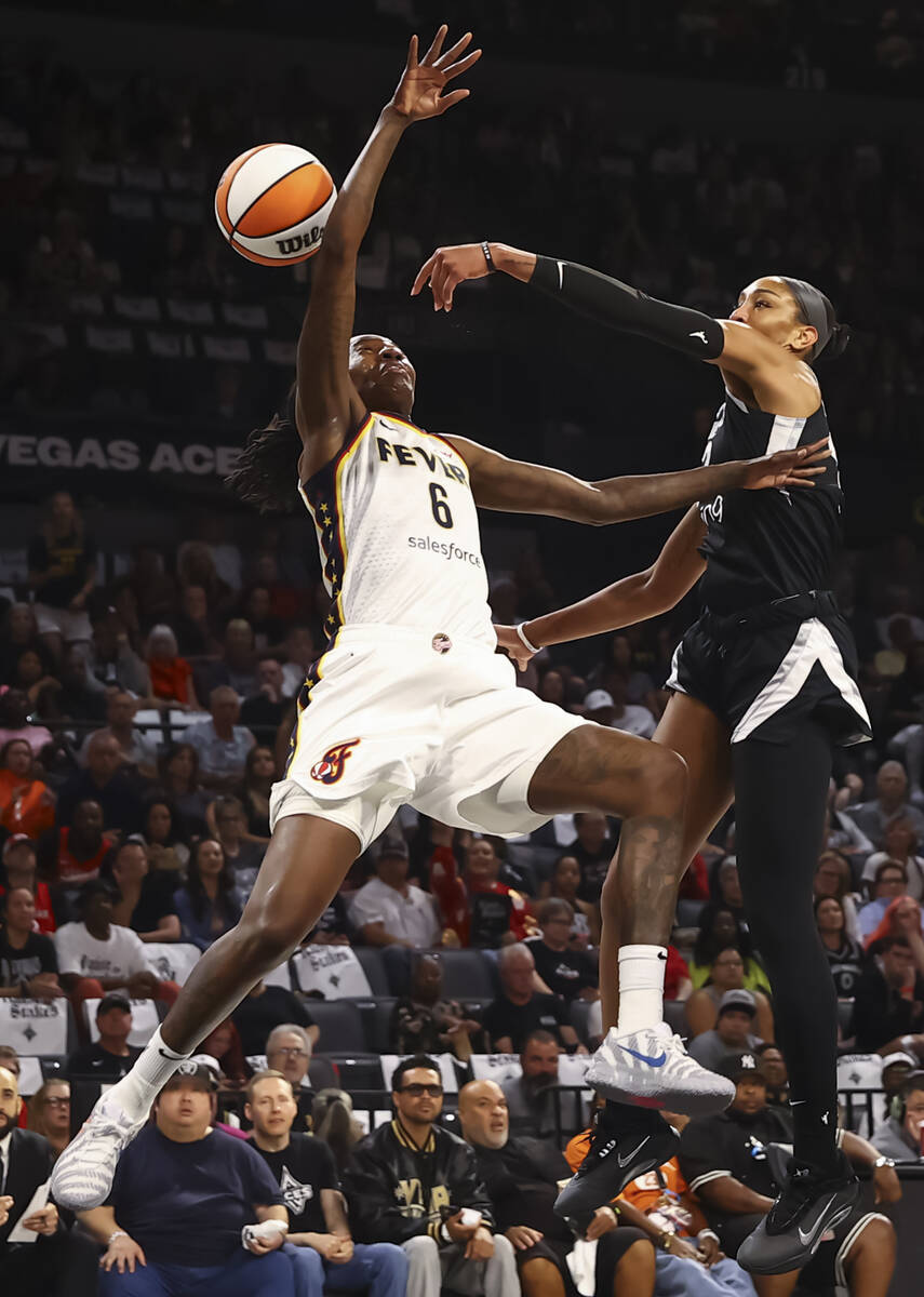Aces center A'ja Wilson (22) blocks the shot of Indiana Fever forward Natasha Howard (6) d ...