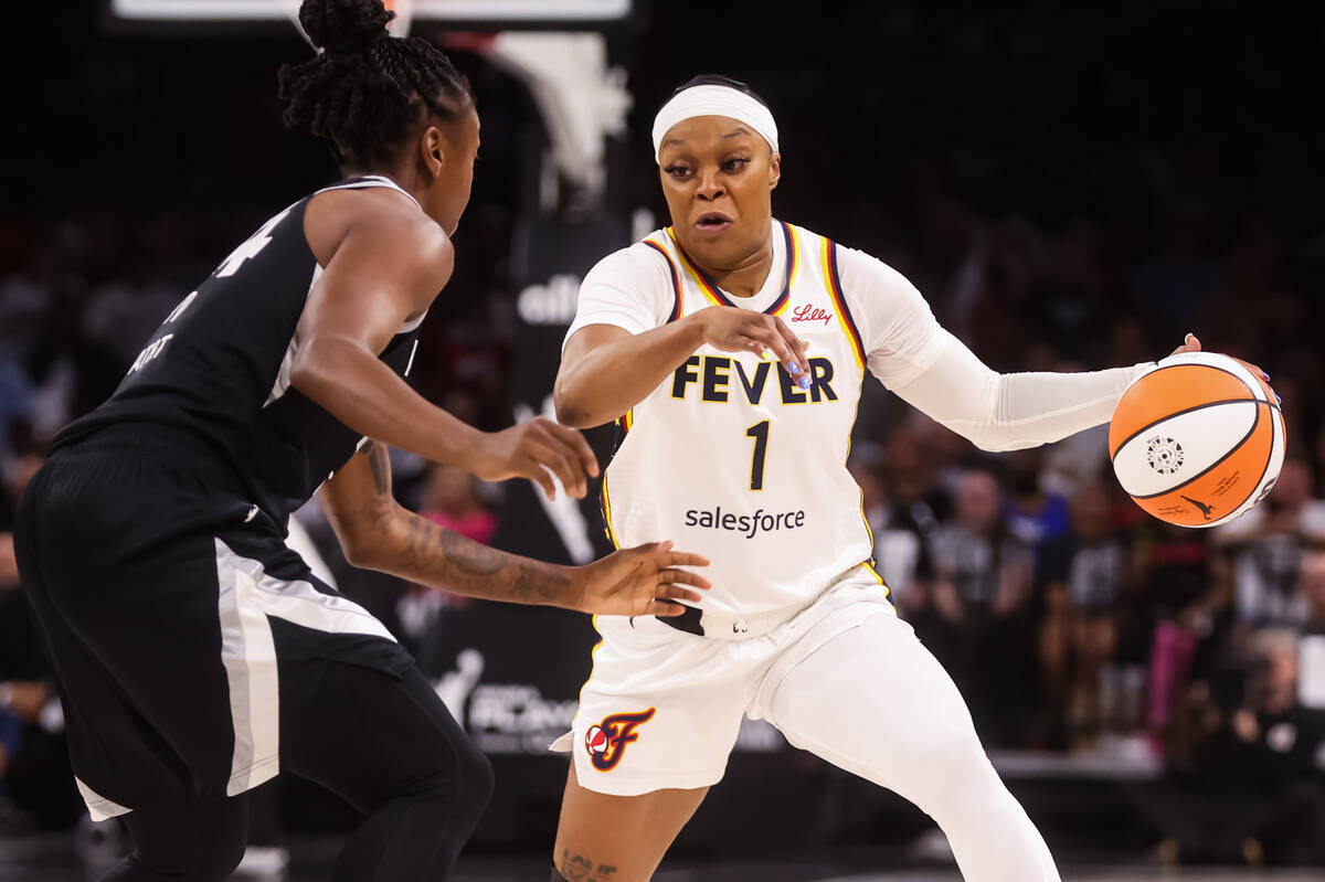 Indiana Fever guard Odyssey Sims (1) drives to the basket against Aces guard Jewell Loyd (24) d ...