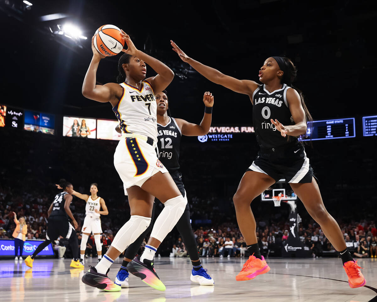 Indiana Fever forward Aliyah Boston (7) looks to pass the ball under pressure from Aces guard J ...
