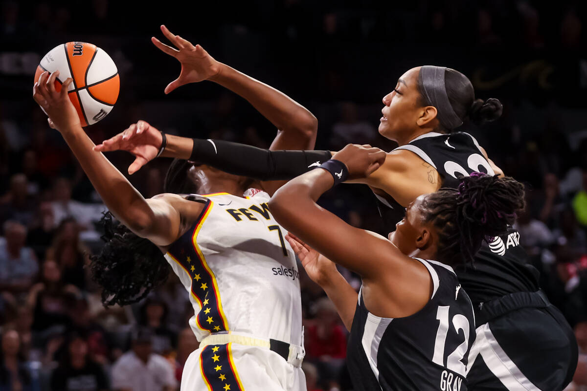 Indiana Fever forward Aliyah Boston (7) tries to hold onto a rebound against Aces center A&#039 ...