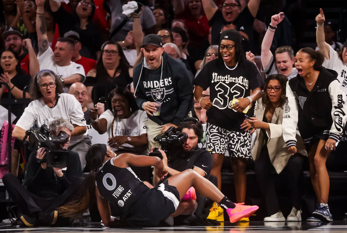 Aces fans celebrate after Aces guard Jackie Young (0) scored while drawing a foul against the I ...