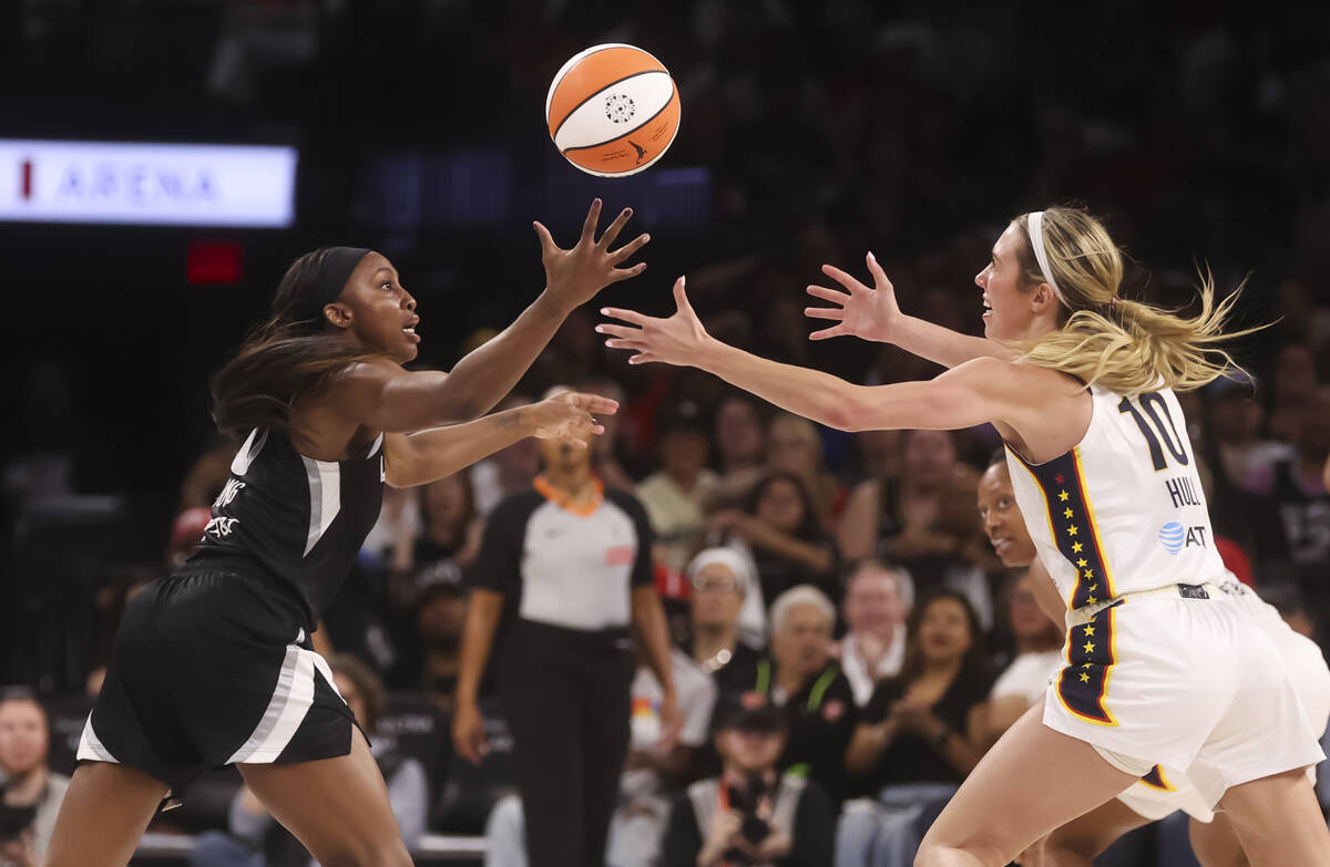 Aces guard Jackie Young (0) and Indiana Fever guard Lexie Hull (10) vie for the ball during the ...