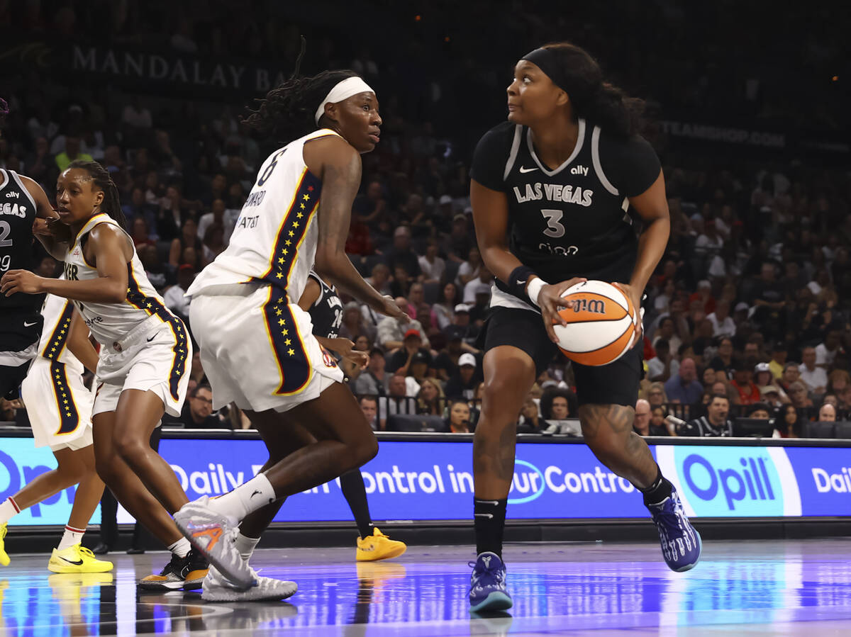 Aces forward NaLyssa Smith (3) looks to shoot against Indiana Fever forward Natasha Howard (6) ...