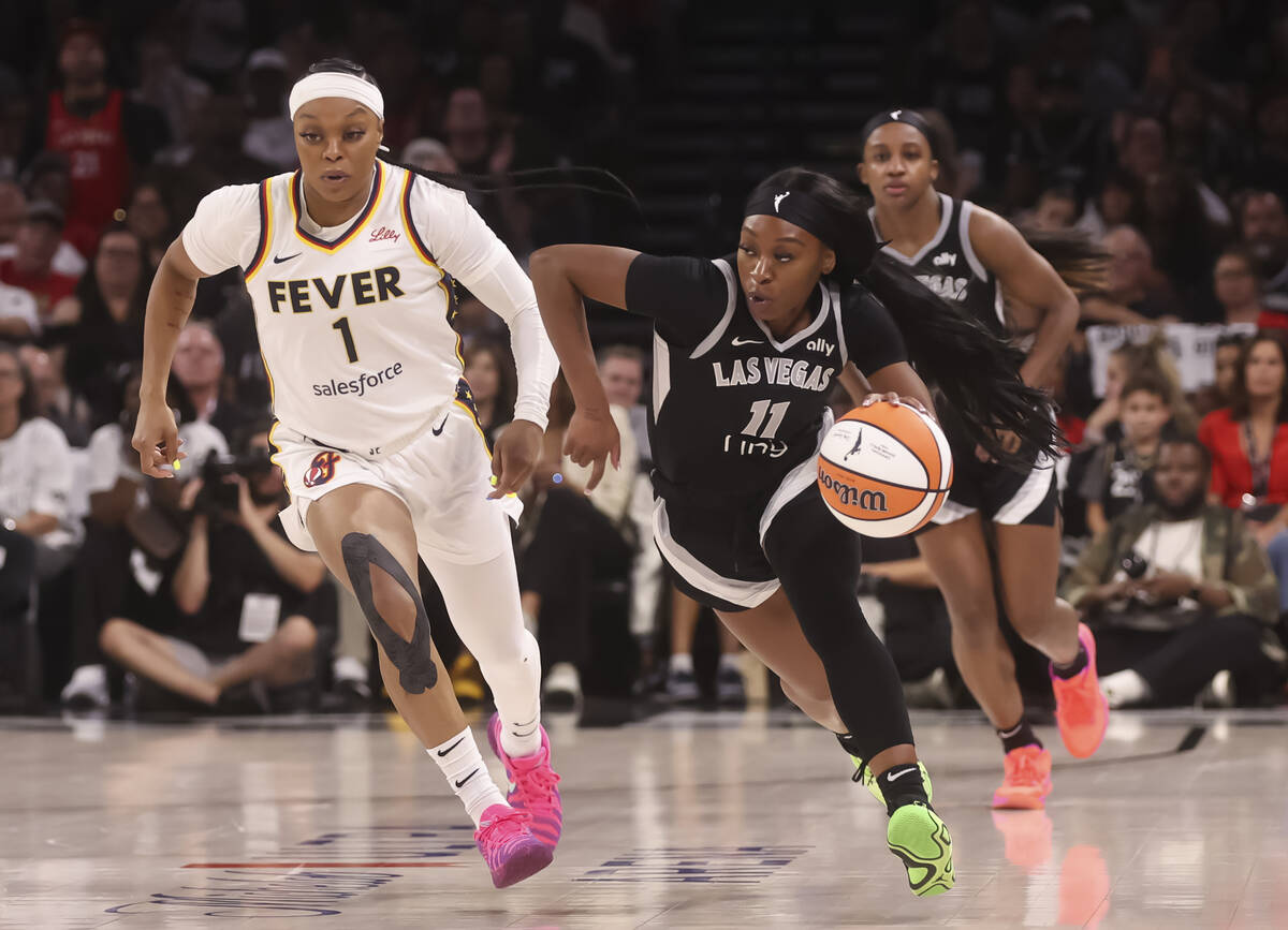 Aces guard Dana Evans (11) brings the ball up court against Indiana Fever guard Odyssey Sims (1 ...