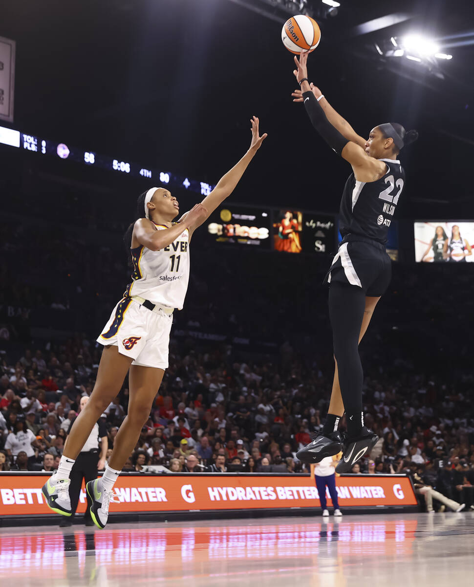 Aces center A'ja Wilson (22) shoots over Indiana Fever forward Brianna Turner (11) during ...